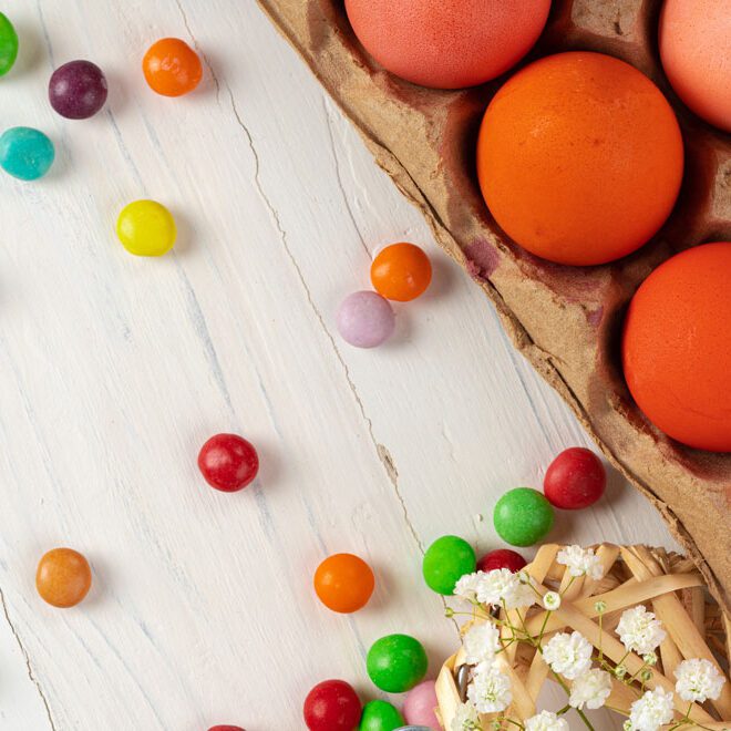 Eggs and candy on a wooden table.
