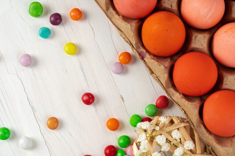 Eggs and candy on a wooden table.