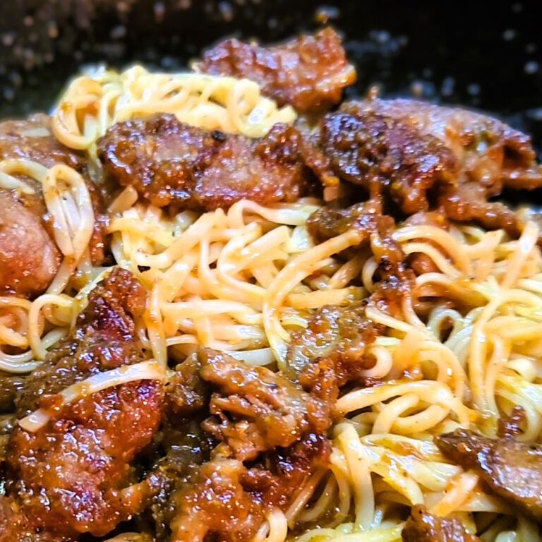 Orange beef over rice noodles.